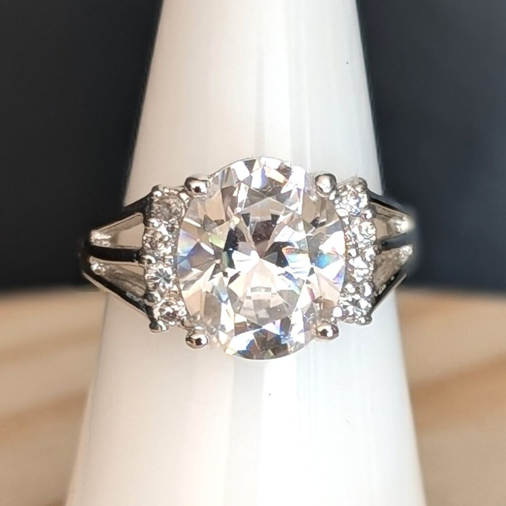 Large round cut faux diamond cocktail ring with side accent stones